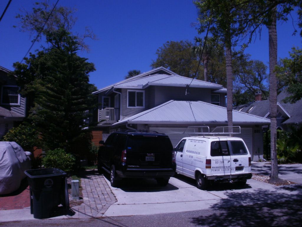 Side and back shot of completed City garage, white body and hunter green trim, green roof.